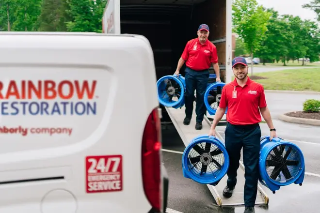 Rainbow Restoration service professionals unloading fans from truck.