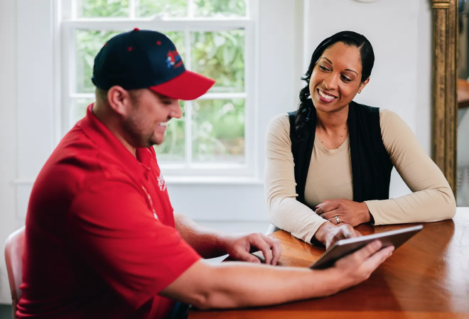 Rainbow Restoration service professional speaks to a customer.